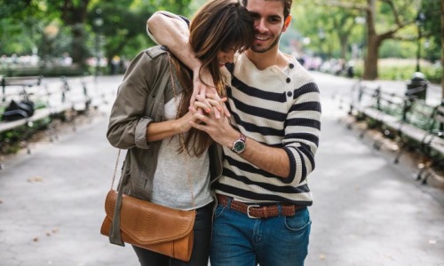 A beautiful community at the heart of all your passions a man and woman walking through a park