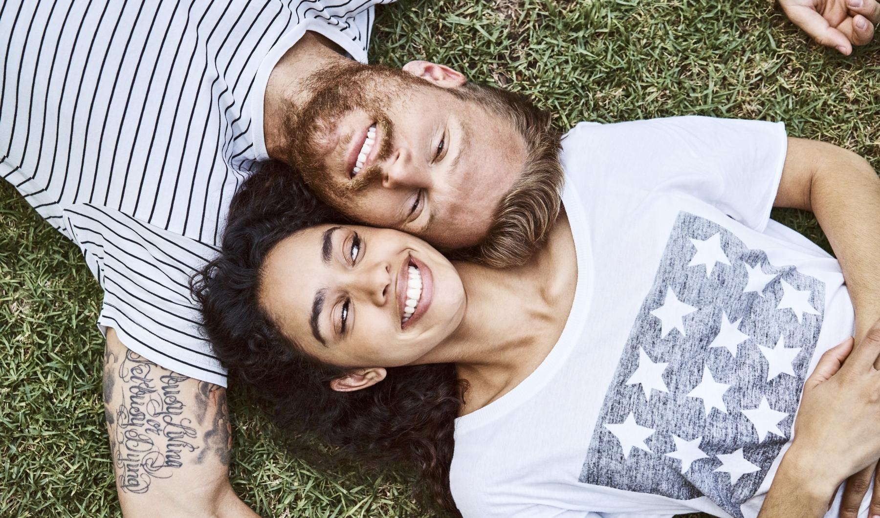 A beautiful community at the heart of all your passions a man and woman lying in the grass