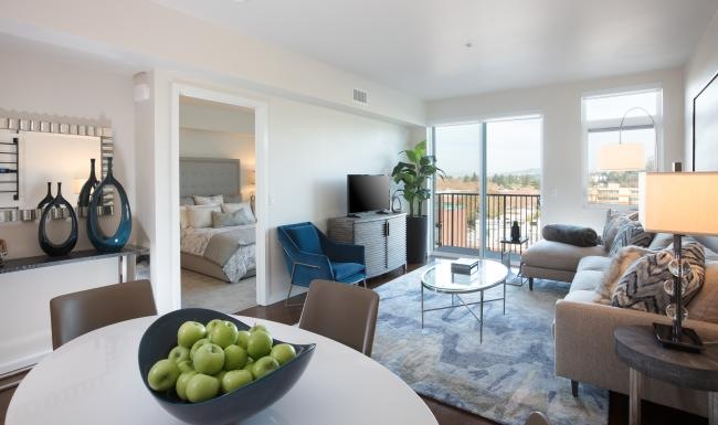 Generous living spaces with beautiful natural lighting a living room with a large glass door to private balcony