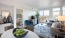 a living room with a large glass door to private balcony