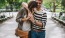 a man and woman walking through a park