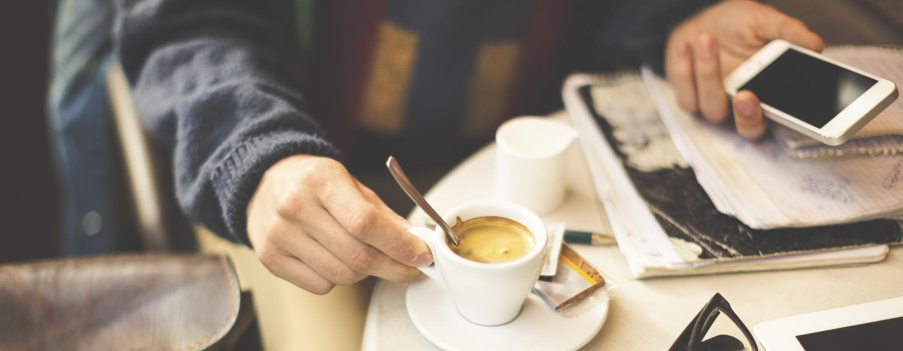 man working at a table in a cafe